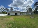 Image of the house from the backyard showing the covered porch and a fire pit at 1476 11Th Ave, Deland, FL 32724