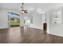 Spacious living room featuring hardwood floors, a ceiling fan, and sliding glass doors to the backyard at 1940 Southern Dunes Blvd, Haines City, FL 33844