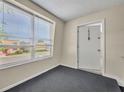 Entryway with a black carpet, door with unit number 1603, and a window showing the building's exterior at 200 Saint Andrews Blvd # 1603, Winter Park, FL 32792