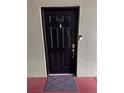Close-up of a black front door with a keypad, doorbell, and peephole for added security at 2035 Dixie Belle Dr # 2035C, Orlando, FL 32812