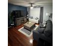 A cozy living room featuring hardwood floors, a ceiling fan, and comfortable seating arrangement at 2035 Dixie Belle Dr # 2035C, Orlando, FL 32812