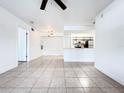 Bright open-concept living space with tile floors flowing into the kitchen with modern appliances at 3028 Parkway Blvd # 105, Kissimmee, FL 34747