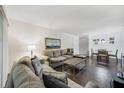 Open living and dining area with hardwood floors, neutral walls, a dining table for four, and a bright atmosphere at 3294 S Semoran Blvd # 14, Orlando, FL 32822