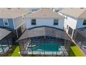Aerial view of the private screened-in pool with lounge chairs and a covered patio area at 3413 Lilac, Davenport, FL 33897