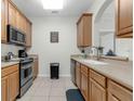 Efficient kitchen with stainless steel appliances and tiled floor at 4102 Breakview Dr # 30603, Orlando, FL 32819