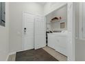Functional laundry room with washer, dryer, and ample shelving at 4102 Breakview Dr # 30603, Orlando, FL 32819