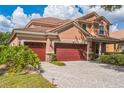 Charming two-story home with three-car garage, lush landscaping, and paver driveway offers curb appeal at 442 Anessa Rose Loop, Ocoee, FL 34761