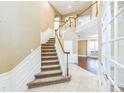 Elegant foyer with a staircase, hardwood flooring, neutral colors, and natural light creates a welcoming entrance at 442 Anessa Rose Loop, Ocoee, FL 34761
