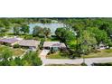 An aerial shot captures the home's setting near a lake and lush greenery at 5301 Pineview Way, Apopka, FL 32703