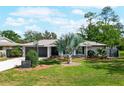 Inviting home featuring a manicured lawn, vibrant landscaping, and a unique palm tree in the front yard at 5301 Pineview Way, Apopka, FL 32703