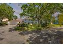 Charming two-story home with blue shutters, mature trees, and a well-manicured lawn at 639 John Anderson Dr, Ormond Beach, FL 32176