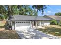Inviting single-story home with a long driveway and a well-kept front yard at 6402 Beechnut Dr, Lakeland, FL 33813