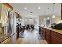 Modern kitchen boasts stainless steel appliances, granite countertops, and stylish pendant lighting at 741 Mystic Oaks Ln, Deland, FL 32724