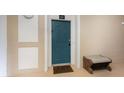 Inviting condo front door, with welcome mat and a bench, offering a warm entrance at 7654 Comrow St # 104, Kissimmee, FL 34747