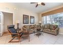 Inviting living room features tile flooring, comfy couches and neutral paint at 7654 Comrow St # 104, Kissimmee, FL 34747