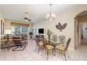 Bright living room with tile floors, stylish dining table, and lots of natural light at 7654 Comrow St # 104, Kissimmee, FL 34747