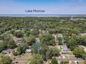 Aerial view of the house surrounded by trees, and showing Lake Monroe in the distance at 810 Catalina Dr, Sanford, FL 32771