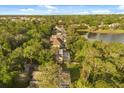 Aerial view showing the backyard pool, mature landscaping, and proximity to a scenic lake at 8800 Torey Pines Ter, Orlando, FL 32819