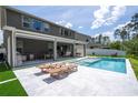 Beautiful pool and patio featuring outdoor kitchen, large patio and modern furniture at 9224 Legado Dr, Windermere, FL 34786