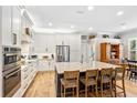Open kitchen with large island, stainless steel appliances, and ample cabinet space at 9880 Montclair Cir, Apopka, FL 32703