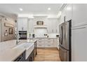 Bright kitchen with white cabinetry, stainless steel refrigerator, and modern countertops at 9880 Montclair Cir, Apopka, FL 32703