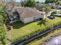 Aerial view of the backyard featuring an in-ground screened pool, fenced yard, and lake views at 1137 Palm Cove Dr, Orlando, FL 32835