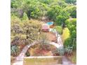 An aerial view of this lovely home surrounded by mature trees and featuring a private backyard pool at 1212 Foxfire Dr, Apopka, FL 32712