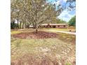 A charming home with mature trees and a well manicured lawn creating an inviting curb appeal at 1212 Foxfire Dr, Apopka, FL 32712