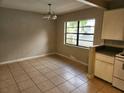 Bright dining room with tile floors, large window, and classic lighting at 132 Terrace Dr, Winter Haven, FL 33884