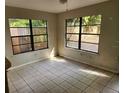 Cozy living room with tile flooring, two big windows, and natural light at 132 Terrace Dr, Winter Haven, FL 33884
