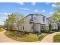 Modern home with stone accents, large windows, and a charming park bench at 1873 White Feather Loop, Oakland, FL 34787