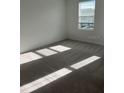 Spacious bedroom with carpet and a large window, offering plenty of natural light at 2081 Viewfinder St, Kissimmee, FL 34758
