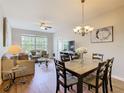 Cozy living and dining area with hardwood floors, large window, and stylish furnishings at 2300 Silver Palm Dr # 205, Kissimmee, FL 34747