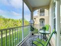 Relaxing screened patio with outdoor seating and a view of the lush green surroundings at 2300 Silver Palm Dr # 205, Kissimmee, FL 34747