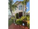 Charming two-story home with well-maintained landscaping and mature palm trees at 2737 Merrieweather Ln, Kissimmee, FL 34743