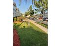 Quiet neighborhood street with well-manicured lawns and mature trees at 2737 Merrieweather Ln, Kissimmee, FL 34743