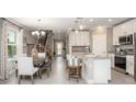 Open-concept dining area with modern chandelier, leading to the kitchen and showcasing the home's layout at 2799 San Marco Way, Winter Haven, FL 33884