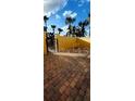 A beautiful brick-paved courtyard is surrounded by a stucco wall and a secure wrought iron gate at 2834 Bella Vista Dr, Haines City, FL 33844