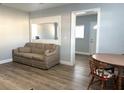 Comfortable living room featuring updated flooring and plenty of room for seating and a dining set at 2975 Avenue G Nw, Winter Haven, FL 33880