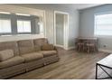 Cozy living room showcasing a neutral color palette, updated flooring, and a dining area at 2975 Avenue G Nw, Winter Haven, FL 33880