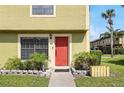 Charming townhome featuring a striking red door and manicured garden at 3251 Oak Lake Pl # 135, Winter Park, FL 32792