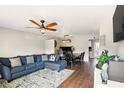 Comfortable living room with an area rug and a stylish ceiling fan at 3251 Oak Lake Pl # 135, Winter Park, FL 32792