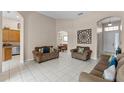 Open-concept living area featuring neutral tones and bright tile floors at 3416 Gerber Daisy Ln, Oviedo, FL 32766