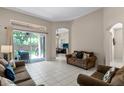 Bright living room with tile flooring, neutral walls, and backyard access at 3416 Gerber Daisy Ln, Oviedo, FL 32766
