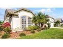 Close up of landscaped yard with verdant shrubs and mulch surrounding the home's foundation at 3617 Cherry Hill Dr, Orlando, FL 32822