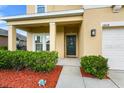Charming home entrance with manicured bushes, mulch, and a welcoming front porch area at 3808 Enchantment Ln, St Cloud, FL 34772