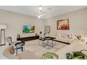 Sunlit living room features modern decor, stylish furniture, and contemporary lighting fixtures at 4418 Shiva Loop, Kissimmee, FL 34746