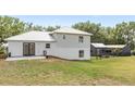 Image shows home's rear exterior elevation with yard and additional shed outbuilding at 7823 Baron Ave, Howey In The Hills, FL 34737
