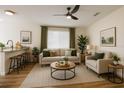 Cozy living room with modern ceiling fan, neutral decor, wood-look floors, and lots of natural light at 101 Dovetail Ct, Apopka, FL 32703