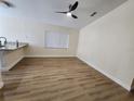 Open living room showcases luxury vinyl plank flooring and a modern ceiling fan at 101 Dovetail Ct, Apopka, FL 32703